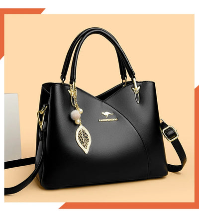 felina™ – sort skuldertaske med elegante vedhæng